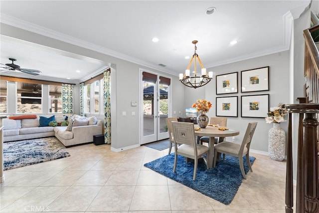 dining area featuring light tile patterned flooring, crown molding, baseboards, and stairs