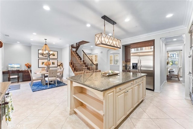 kitchen featuring light tile patterned floors, cream cabinets, open shelves, and built in fridge