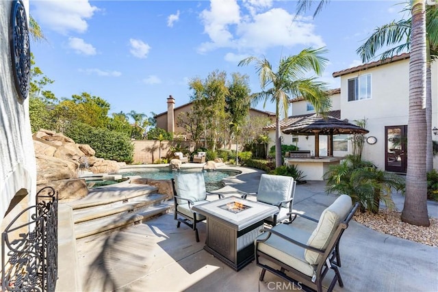 view of patio / terrace with a fenced in pool and a fire pit