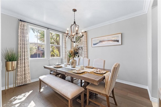 dining space with a chandelier, crown molding, baseboards, and wood finished floors