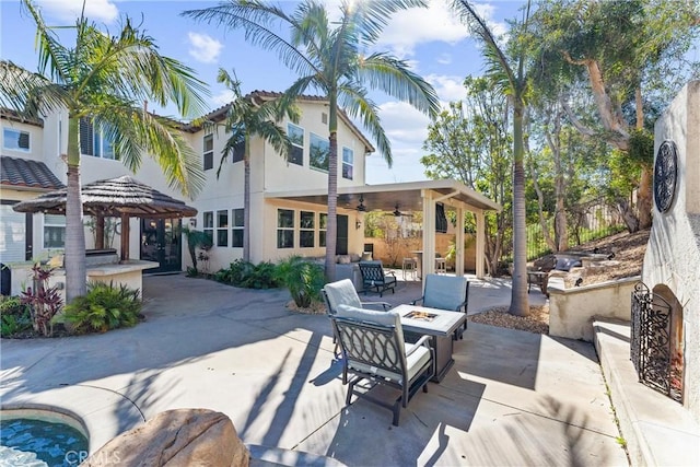 view of patio / terrace with ceiling fan, a gazebo, and an outdoor fire pit