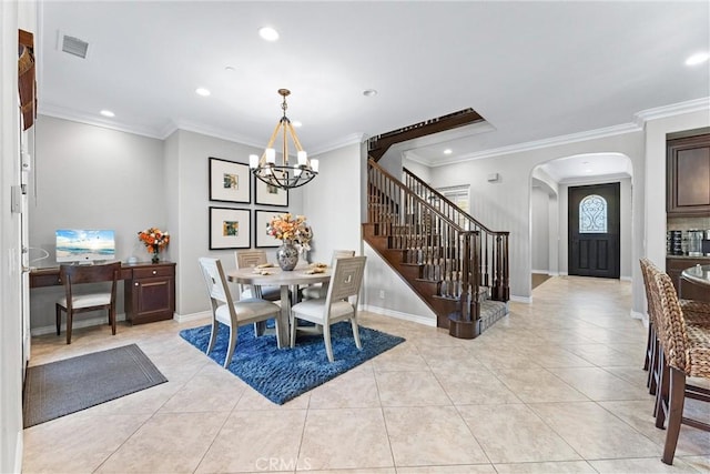 dining room with arched walkways, ornamental molding, an inviting chandelier, stairs, and light tile patterned flooring