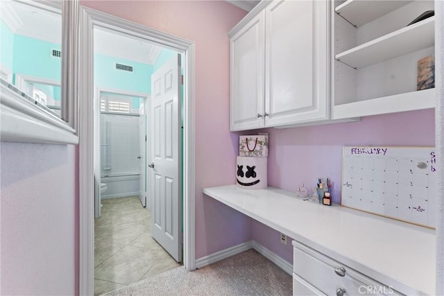 home office with baseboards, visible vents, and light tile patterned flooring