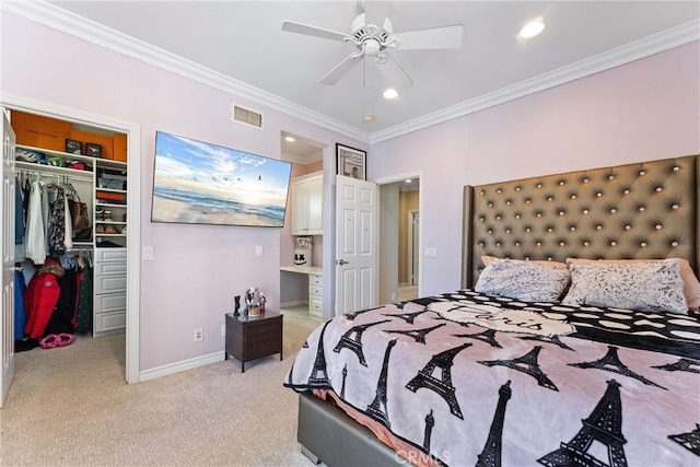 bedroom featuring light colored carpet, visible vents, a spacious closet, a closet, and crown molding