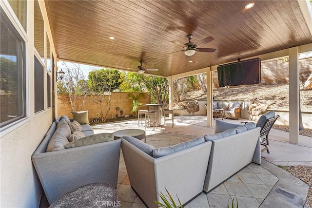 view of patio / terrace featuring ceiling fan, fence, an outdoor hangout area, and outdoor dining space