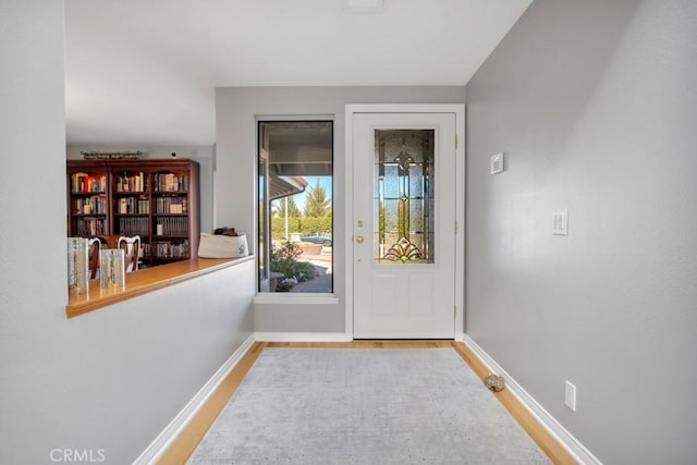 entryway featuring baseboards and wood finished floors