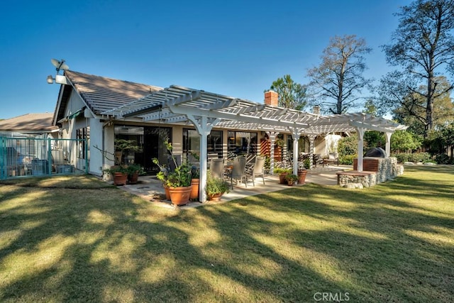 back of house featuring a yard, fence, a pergola, and a patio