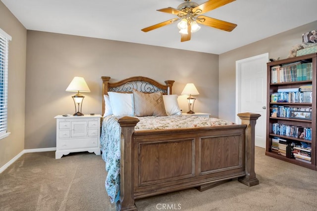 carpeted bedroom with ceiling fan and baseboards