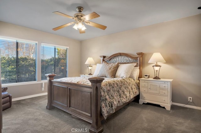 bedroom featuring baseboards, dark carpet, and ceiling fan