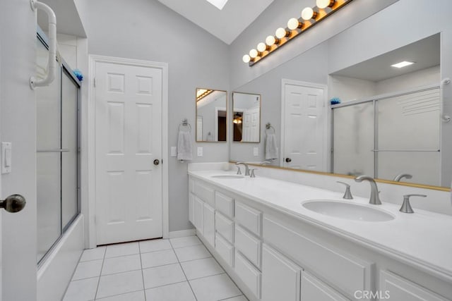 bathroom featuring lofted ceiling, tile patterned flooring, a sink, and enclosed tub / shower combo