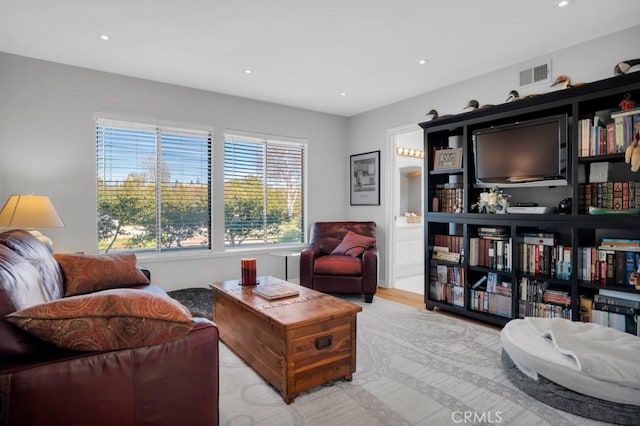 living area with recessed lighting and visible vents