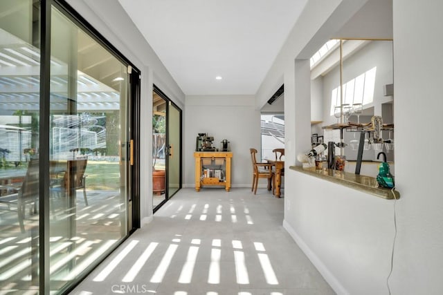 doorway to outside featuring baseboards