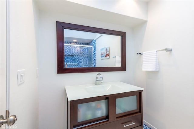 bathroom featuring a shower and vanity