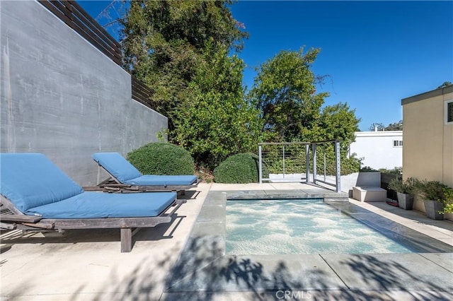 view of patio / terrace featuring a swimming pool and fence