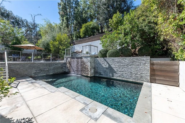 view of swimming pool featuring a swimming pool, a patio area, and a fenced backyard