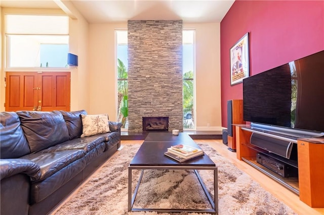 living room with light wood finished floors and a fireplace