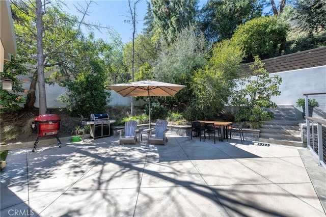 view of patio / terrace with outdoor dining area, fence, and area for grilling