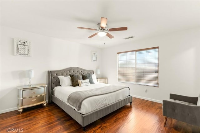 bedroom with wood-type flooring, visible vents, ceiling fan, and baseboards