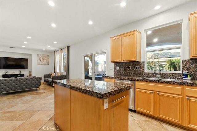 kitchen with a sink, open floor plan, a center island, dishwasher, and tasteful backsplash