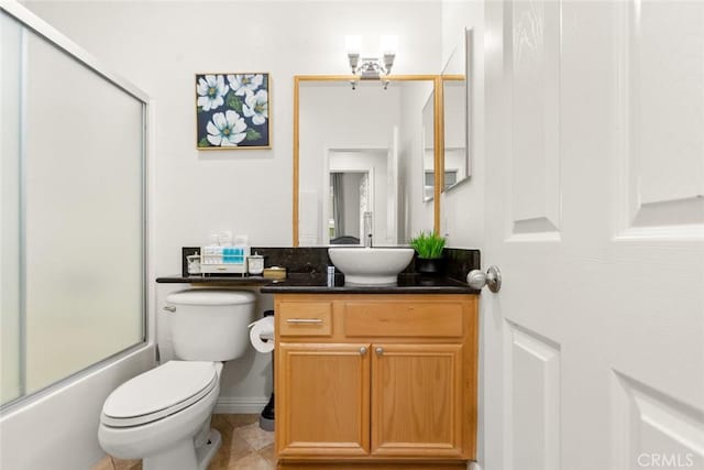 bathroom with shower / bath combination with glass door, vanity, toilet, and tile patterned floors