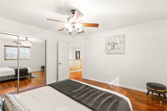 bedroom with ceiling fan, a closet, baseboards, and wood finished floors