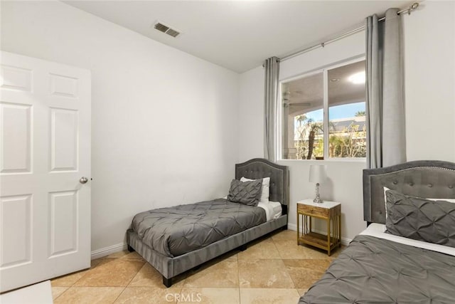 bedroom featuring light tile patterned floors, baseboards, and visible vents