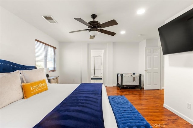 bedroom with baseboards, visible vents, wood finished floors, and recessed lighting