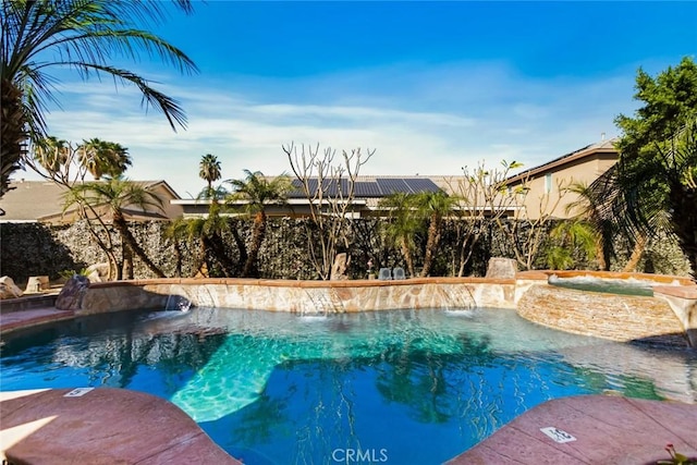 outdoor pool with a fenced backyard