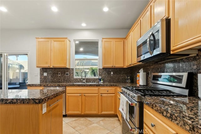 kitchen featuring light tile patterned flooring, recessed lighting, a sink, appliances with stainless steel finishes, and backsplash