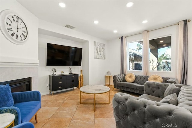 living area with recessed lighting, visible vents, a fireplace, and light tile patterned floors