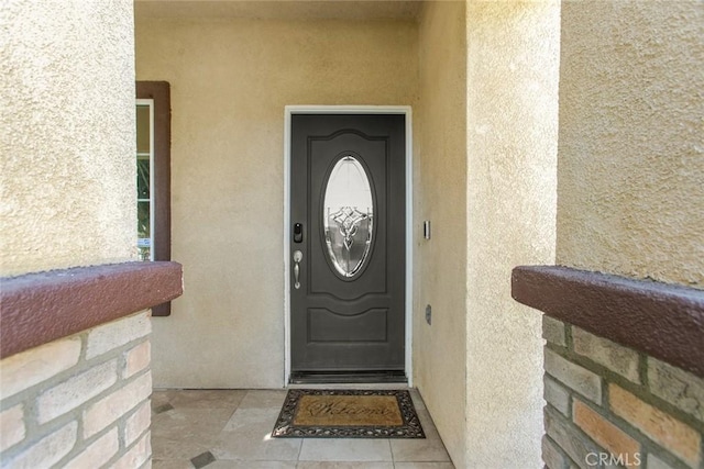 property entrance with stucco siding