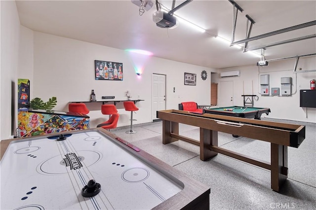 game room featuring a garage, speckled floor, billiards, and a wall mounted AC