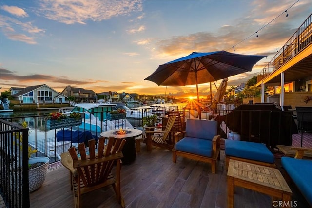 deck with a fire pit and a water view