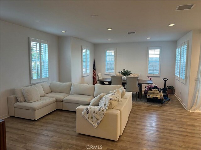 13906 Gazania Ln, Fontana, CA 92336 - living area featuring healthy amount of natural light, wood finished floors, and recessed lighting