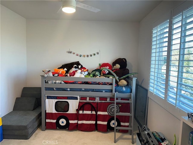 bedroom with carpet floors and multiple windows