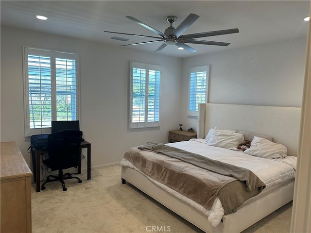 bedroom featuring recessed lighting, light colored carpet, visible vents, and multiple windows