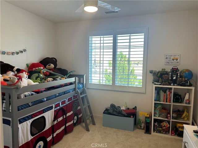 bedroom featuring visible vents, ceiling fan, and light carpet