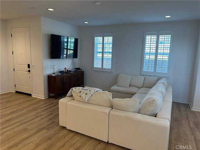 13906 Gazania Ln, Fontana, CA 92336 - living room with light wood-style flooring and recessed lighting