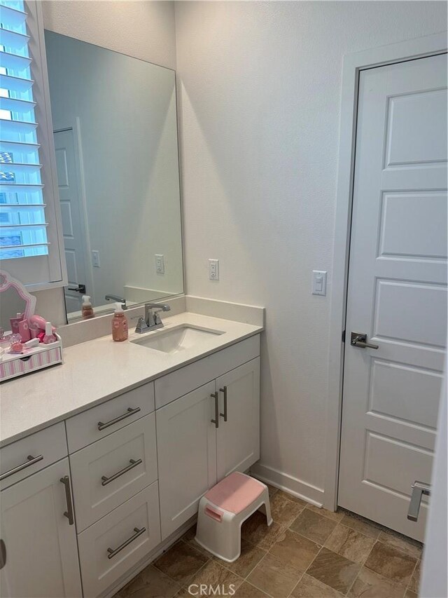 13906 Gazania Ln, Fontana, CA 92336 - bathroom with vanity and stone finish floors