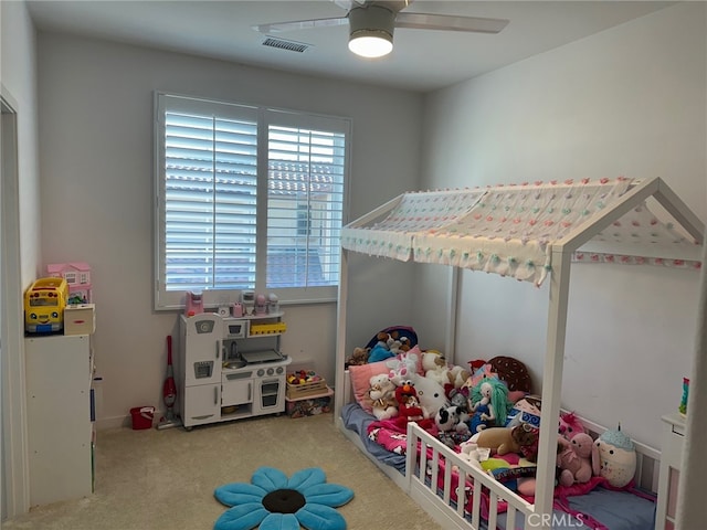 bedroom featuring a ceiling fan, visible vents, and carpet flooring