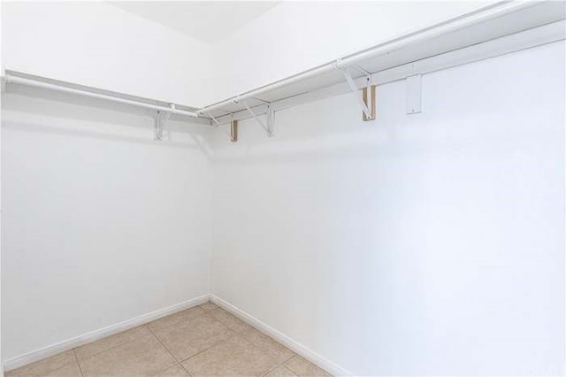 spacious closet featuring light tile patterned floors