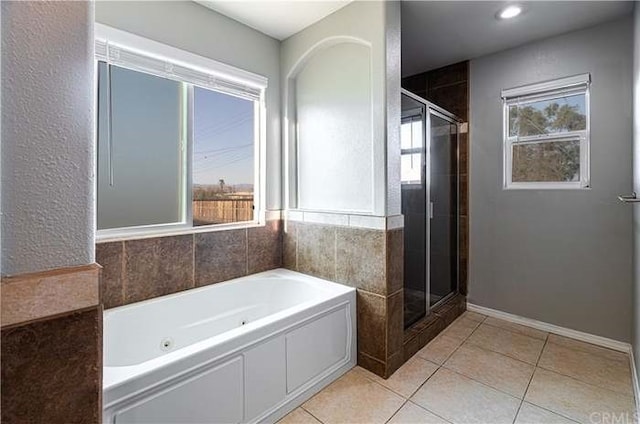 full bath with tile patterned flooring, a bath, and a shower stall