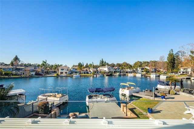 dock area with a residential view and a water view