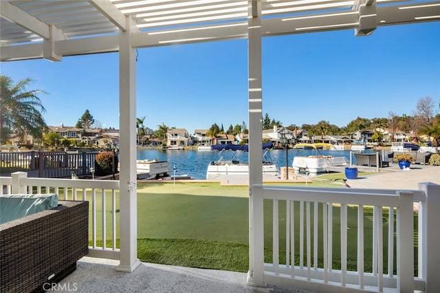 view of patio / terrace with a water view, a residential view, and a pergola