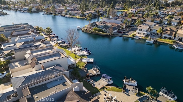 drone / aerial view featuring a residential view and a water view