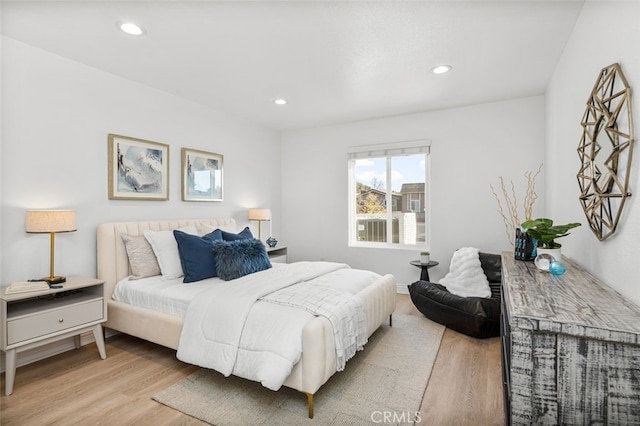 bedroom with light wood finished floors and recessed lighting