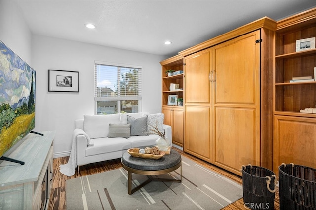 sitting room featuring baseboards, recessed lighting, and light wood-style floors