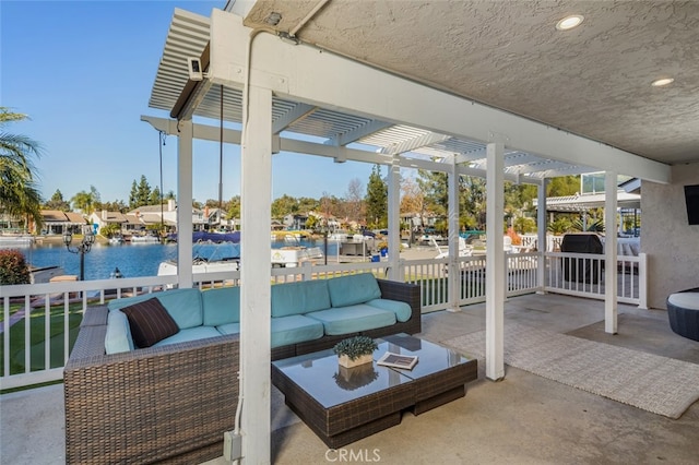 view of patio featuring a water view, an outdoor living space, and a pergola