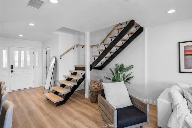 foyer with visible vents, stairs, light wood-style flooring, and recessed lighting