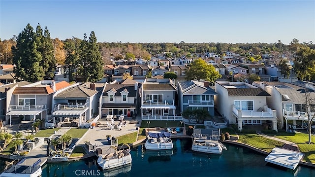 birds eye view of property featuring a water view and a residential view